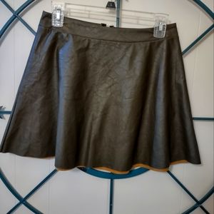 Brown leather by tyche size Medium.zips up the back in great cond..